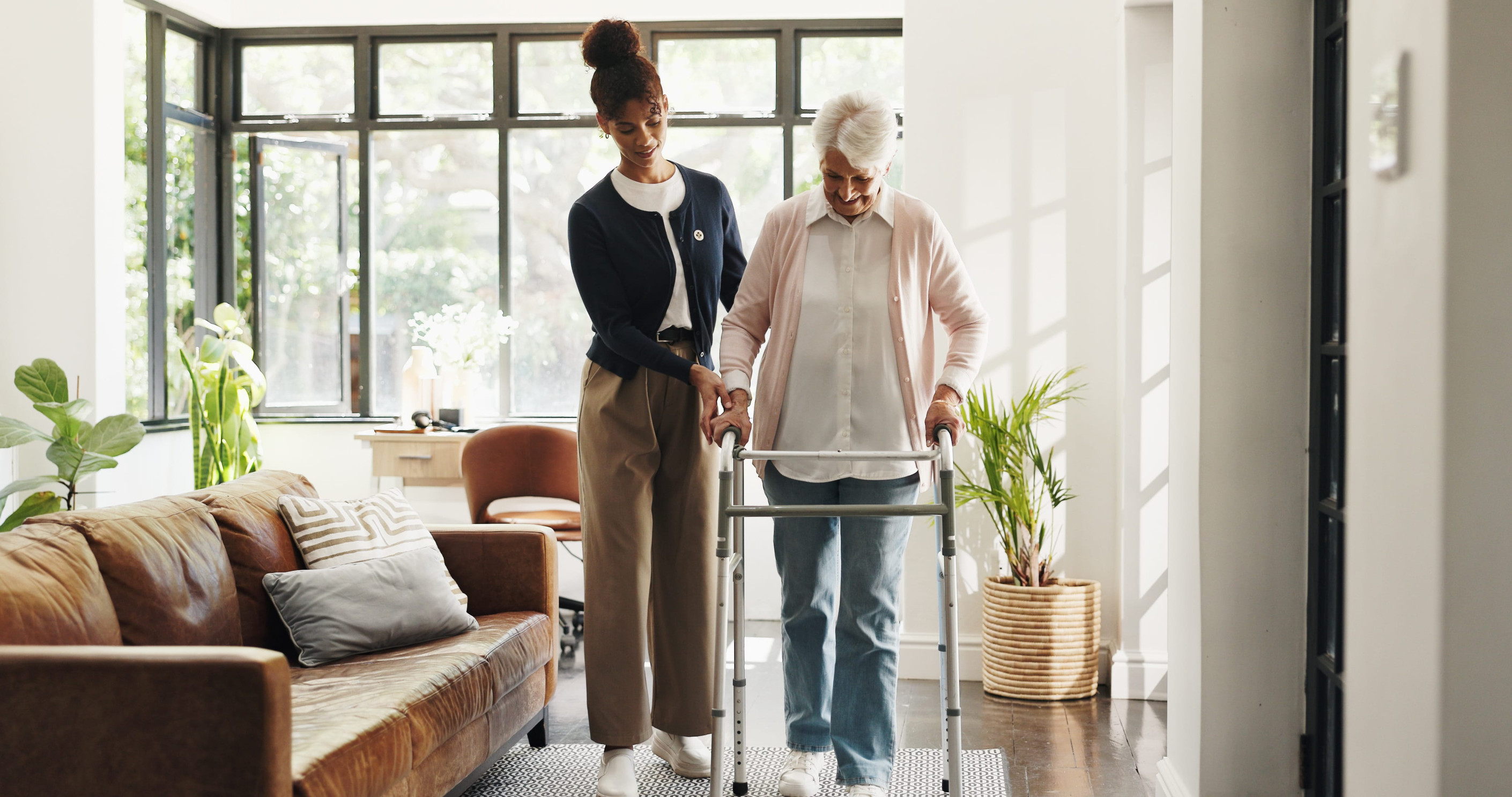 A househelp helping an elderly to walk