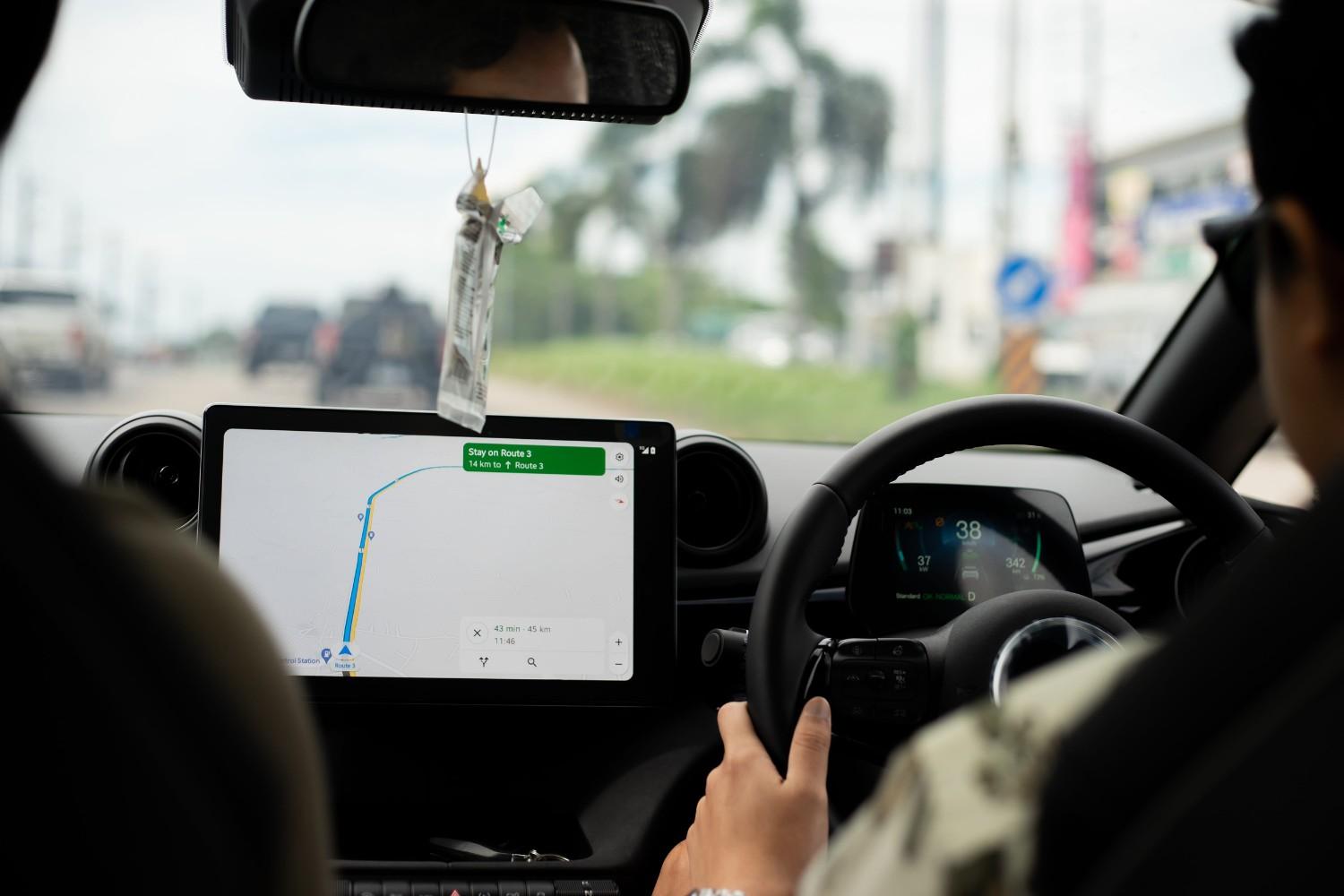 A Man Driving Using A Gps Navigation