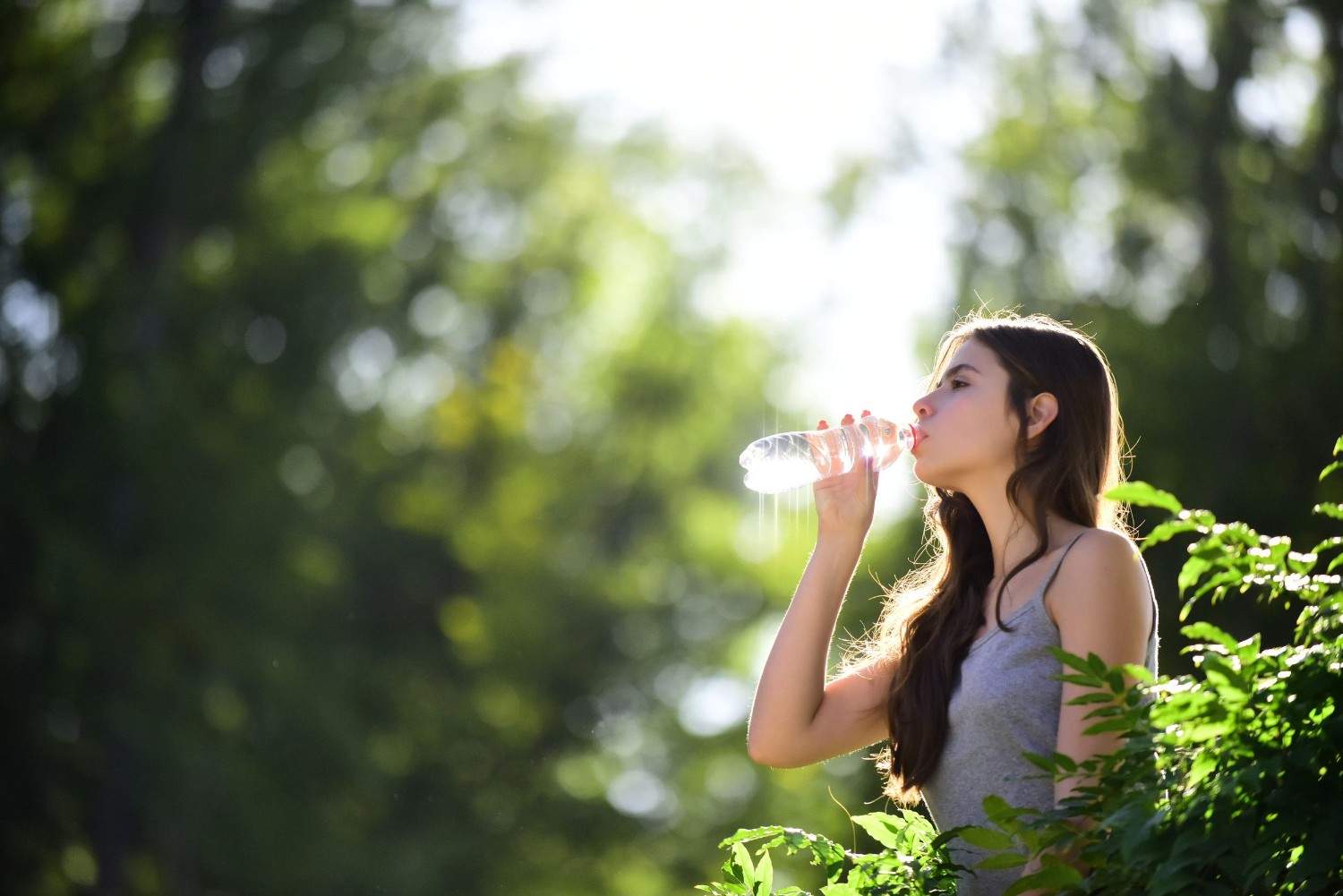 A Woman Drinking Water From A Bottle