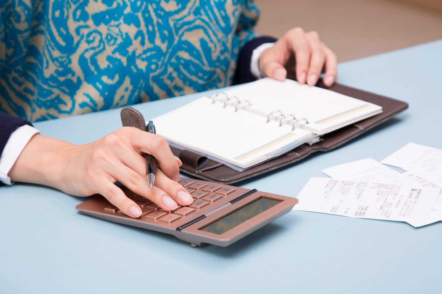 A Woman Planning A Budget For Travel
