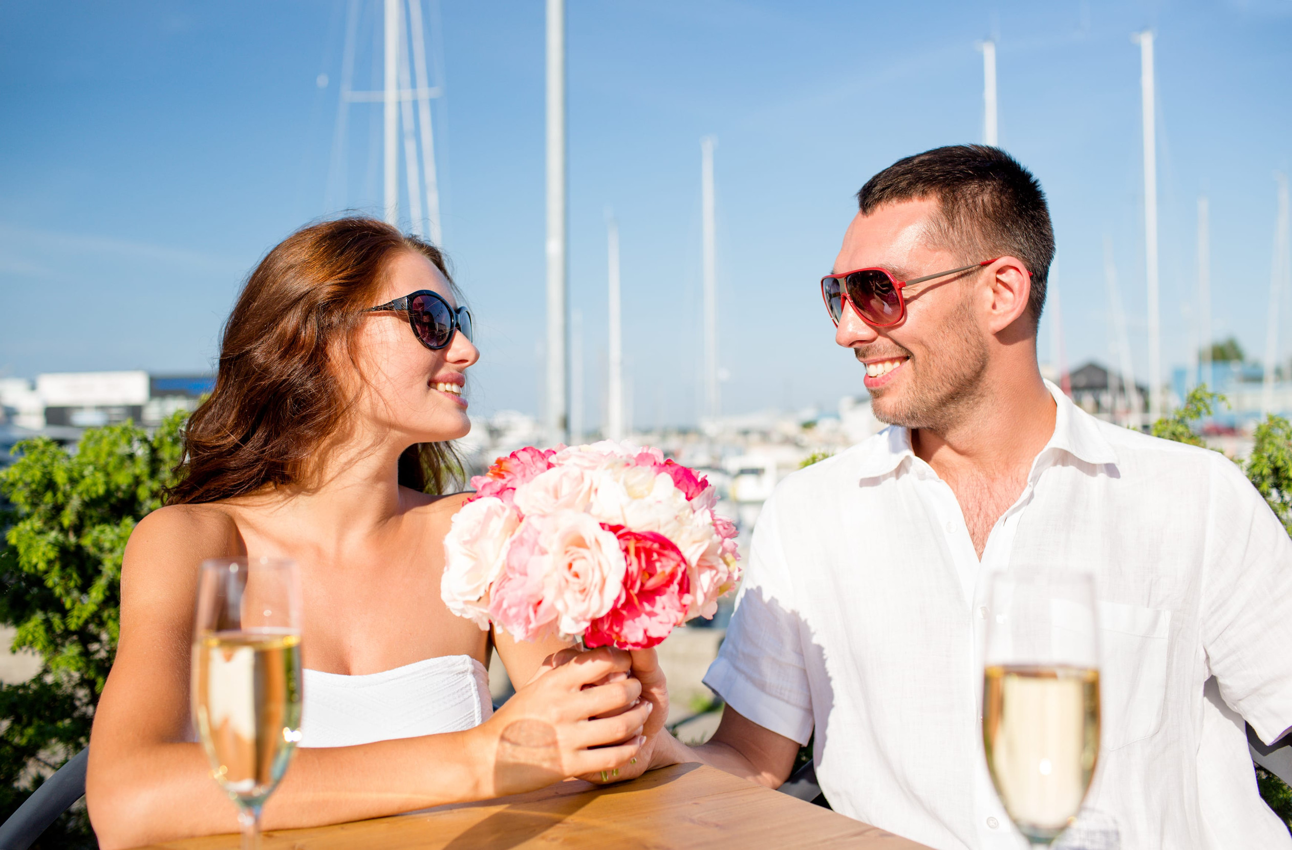 A young man giving a bouquet to a girl
