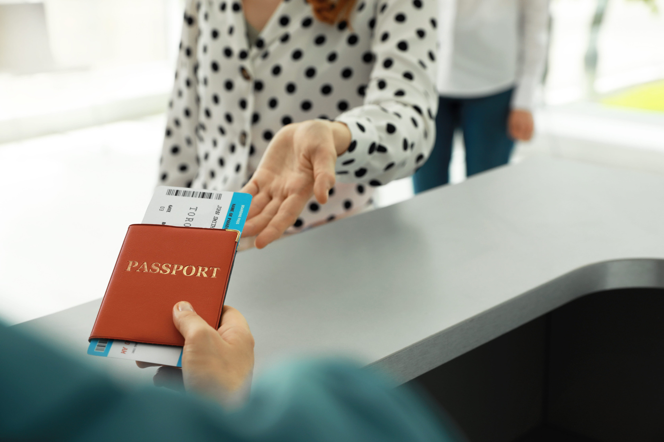Agent Giving Passport And Ticket To Woman