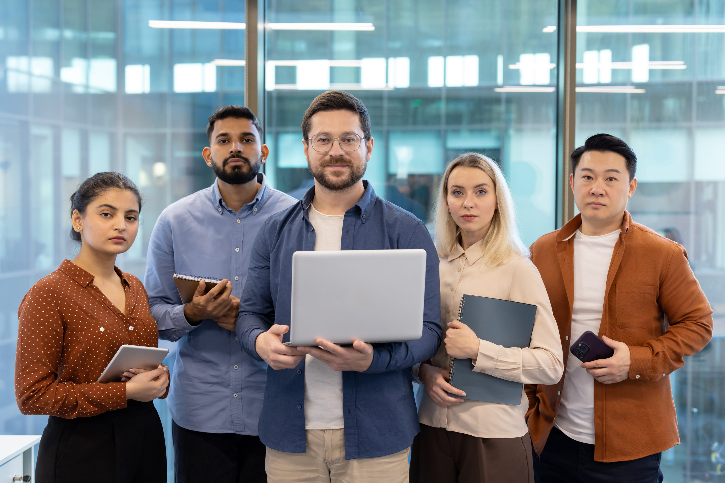 Colleagues standing with laptops