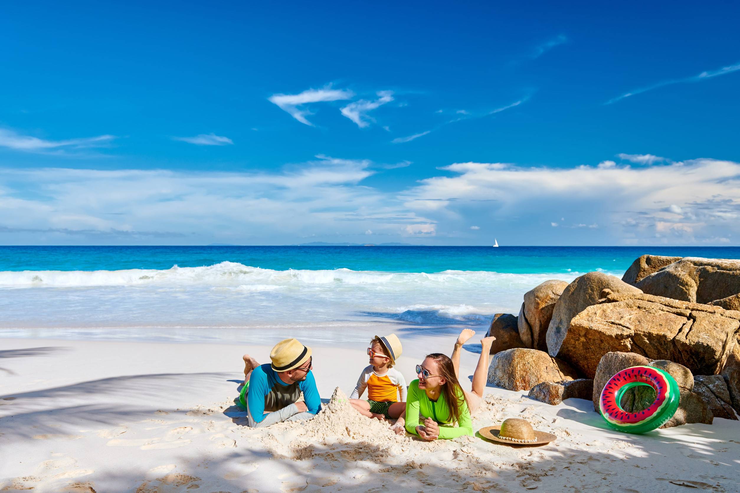 Family Relaxing On A Seychelles Beach