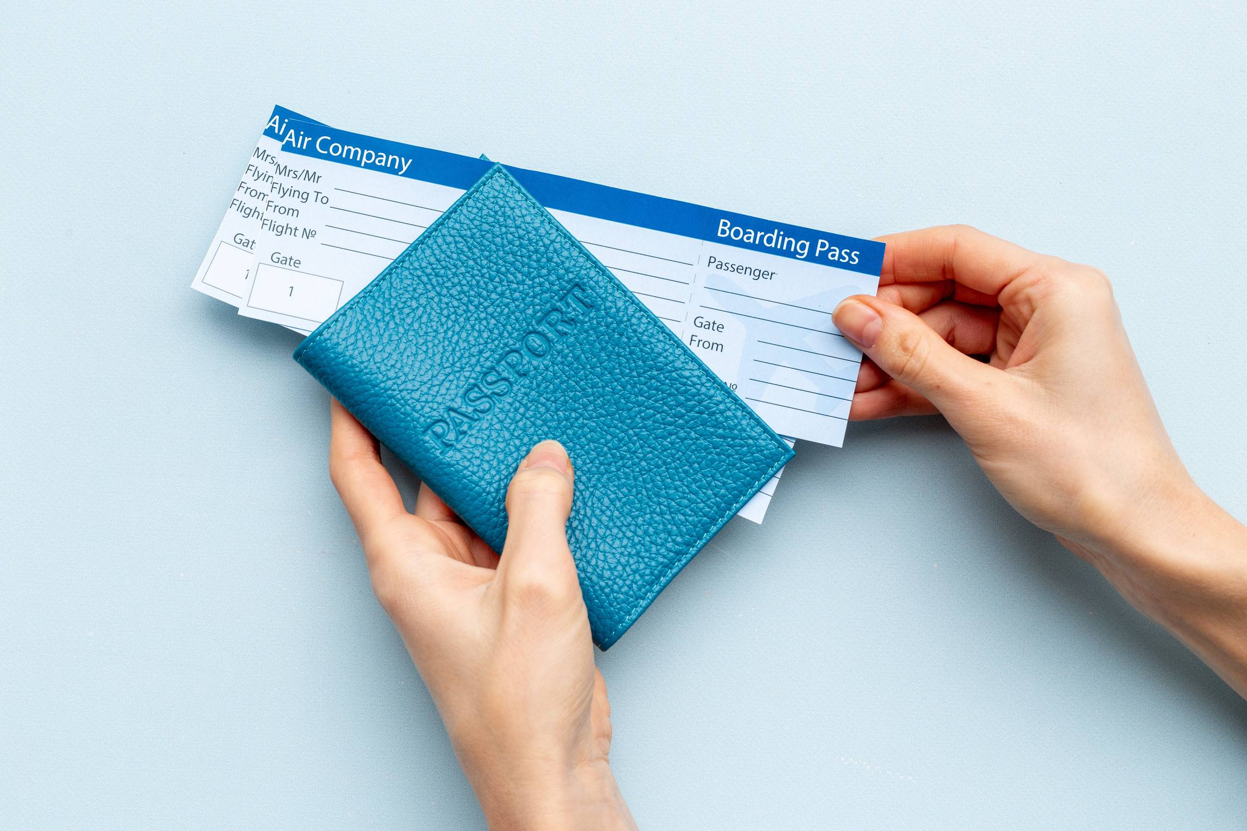 Hand Holding Passport with Tickets
