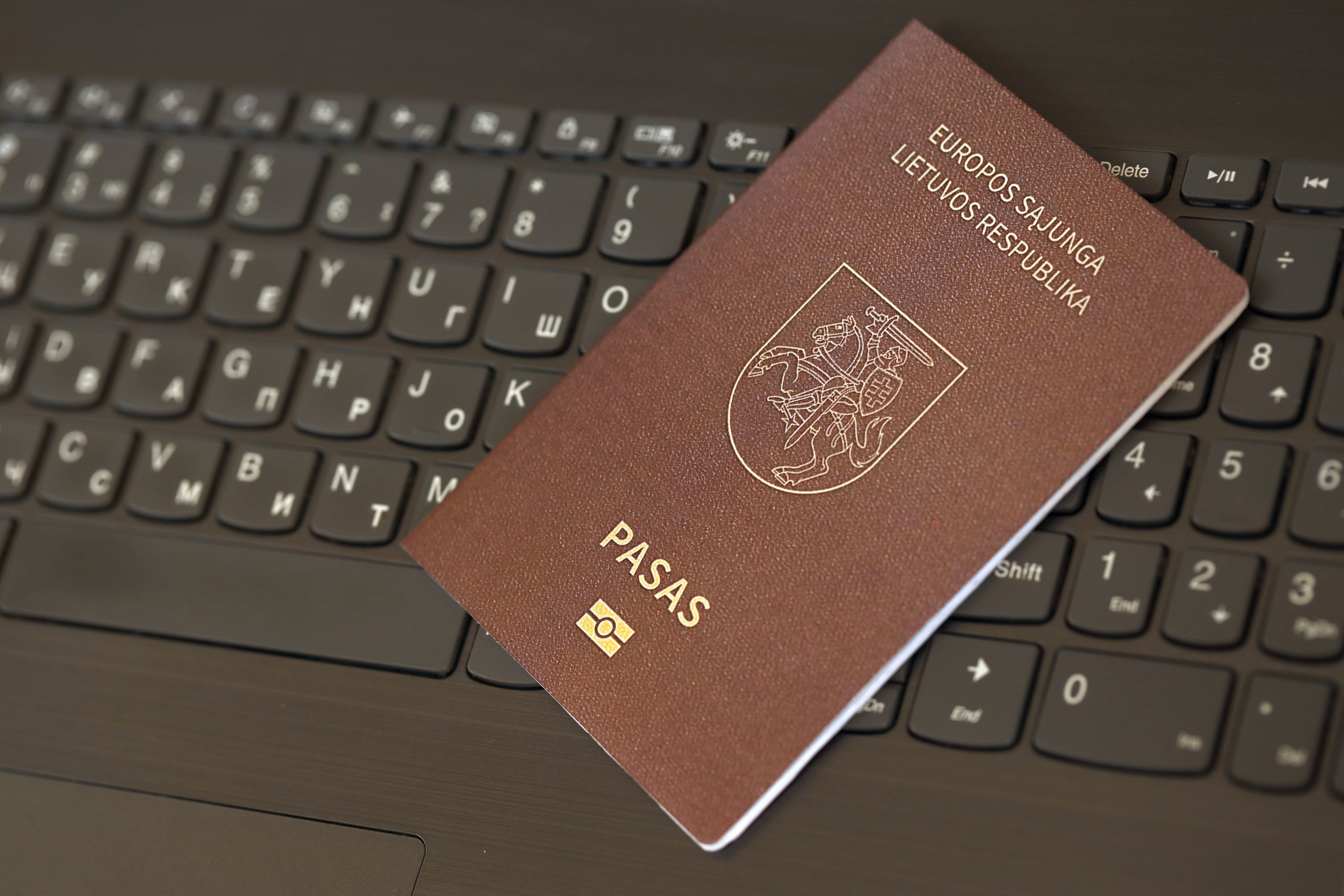 Lithuania Passport on Laptop Keyboard