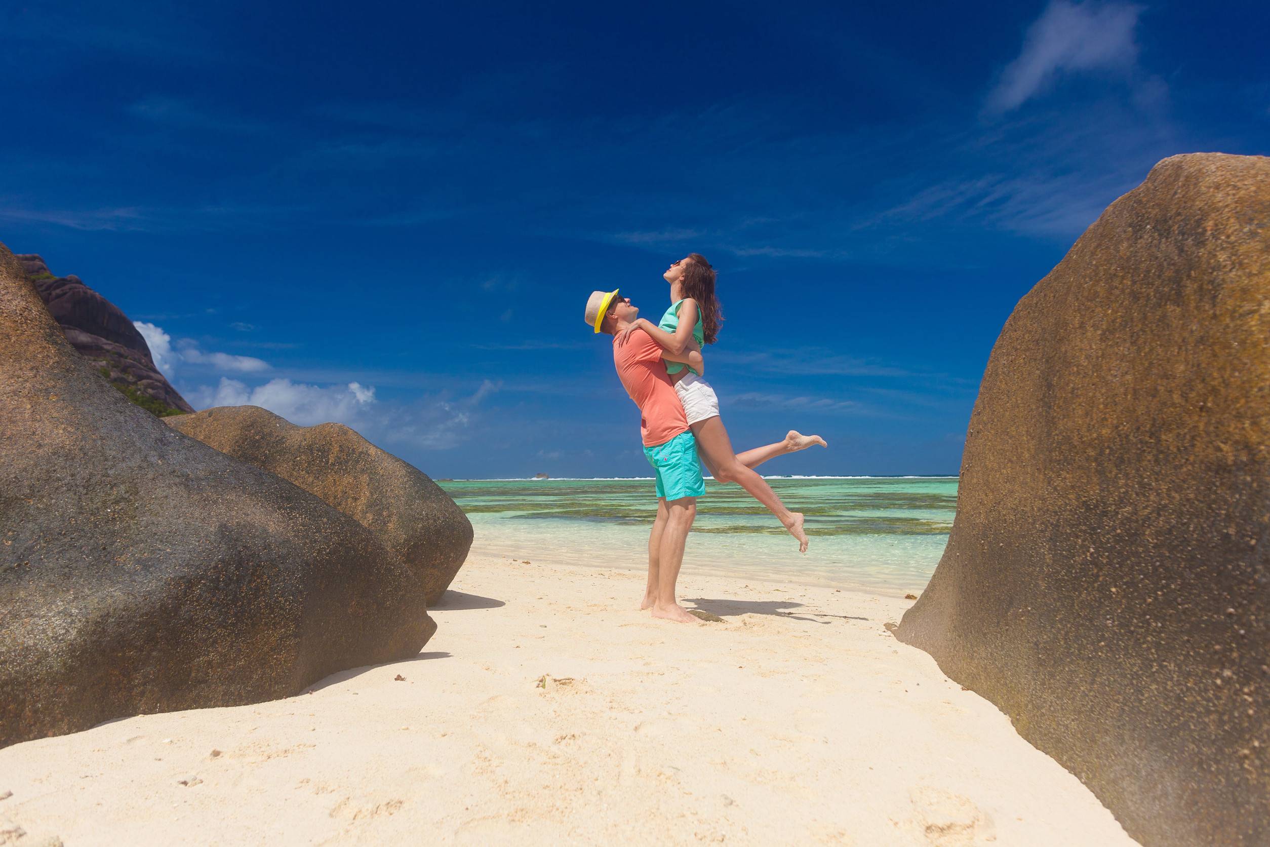 Newlyweds Embracing On A Seychelles Beach