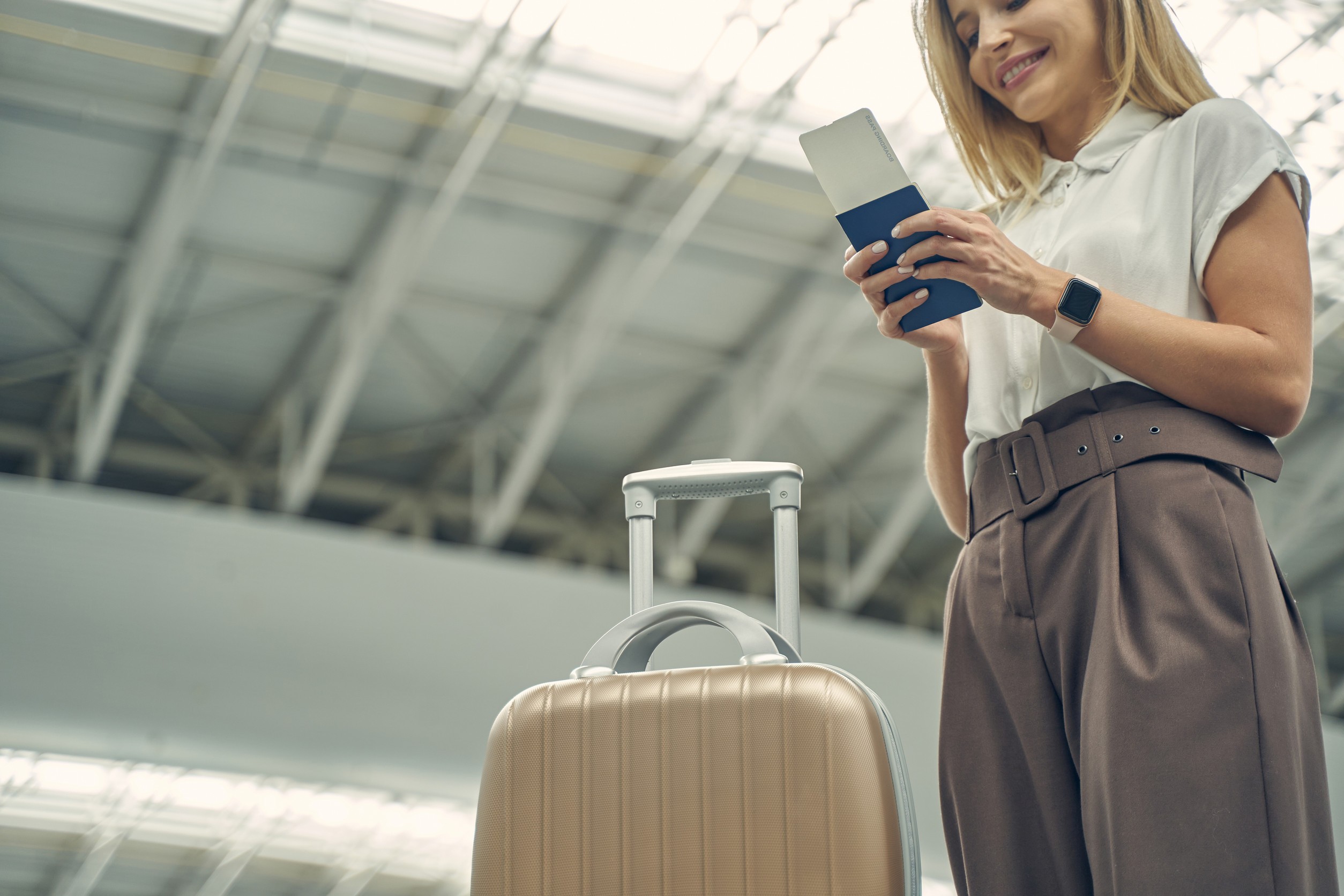 Woman looking at boarding pass and passport